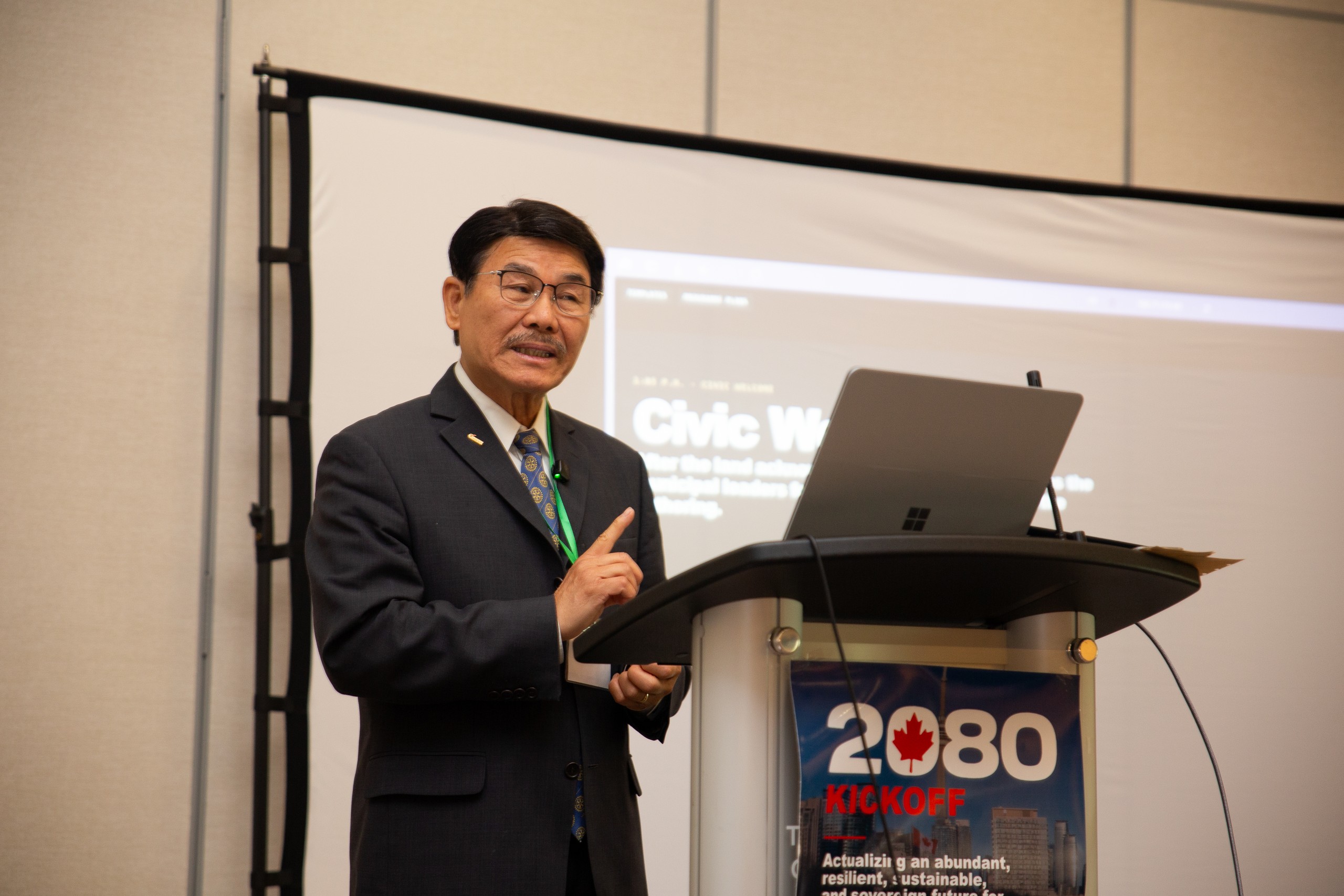 Alan Ho speaking at the podium during the civic welcome.